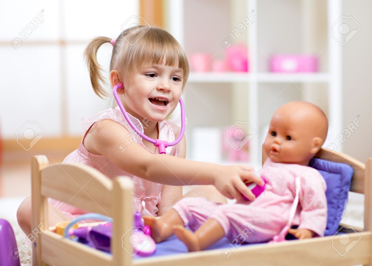 girl playing with dolls